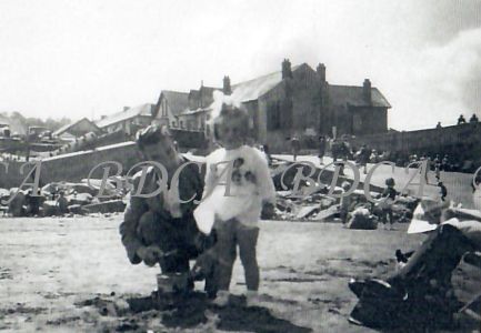 58 .4  man with child slipway beach
